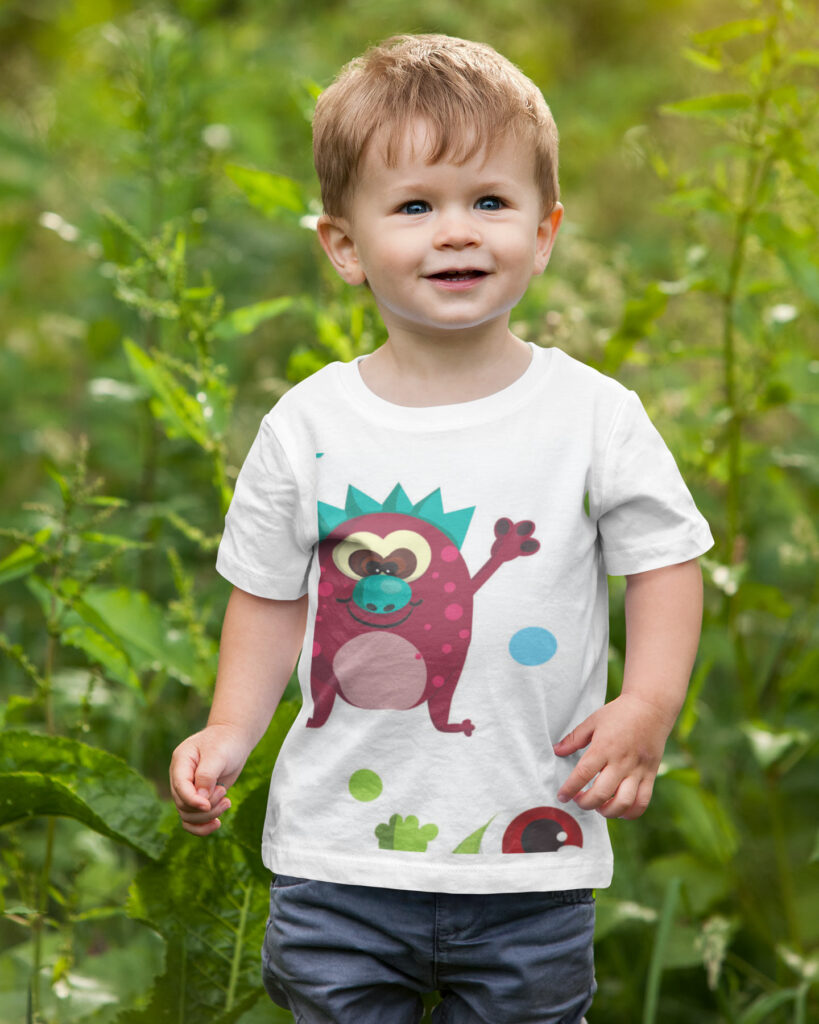 Monsters-pattern-mockup-on-a-toddler-wearing-a-t-shirt-and-walking-in-nature