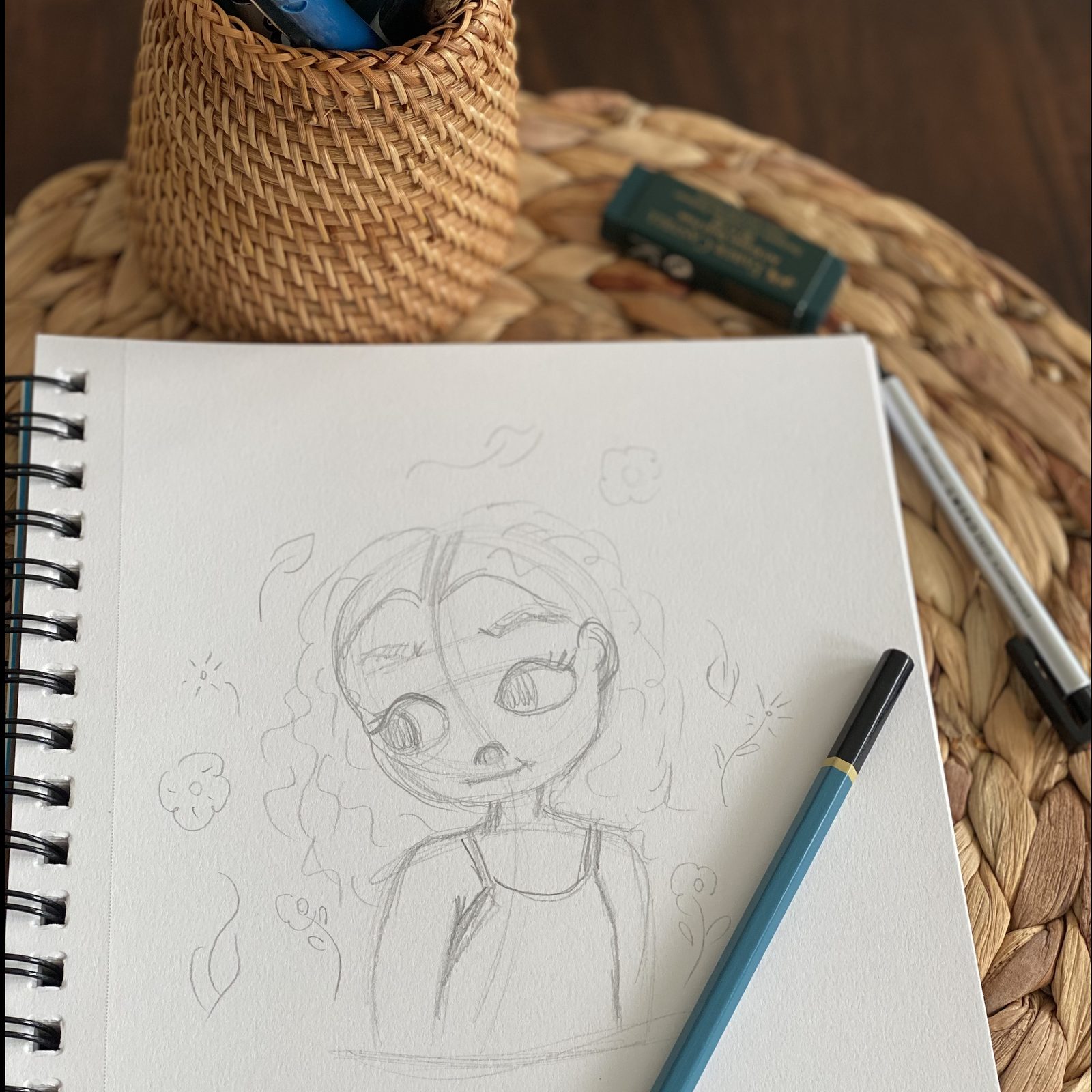 Character illustration sketch in progress on a Leonor Jimenez Design Studio desk